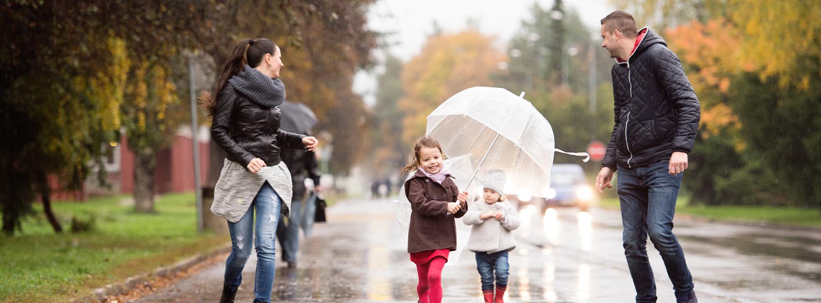 family walking in the rain
