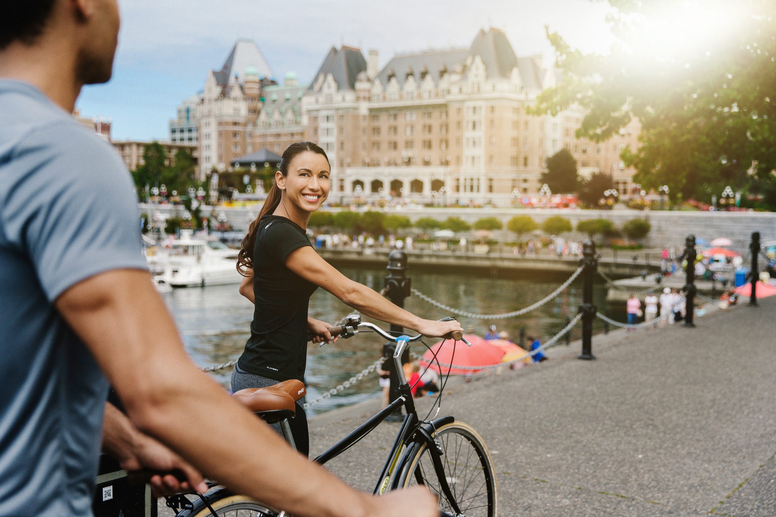 a woman pushing a bicycle