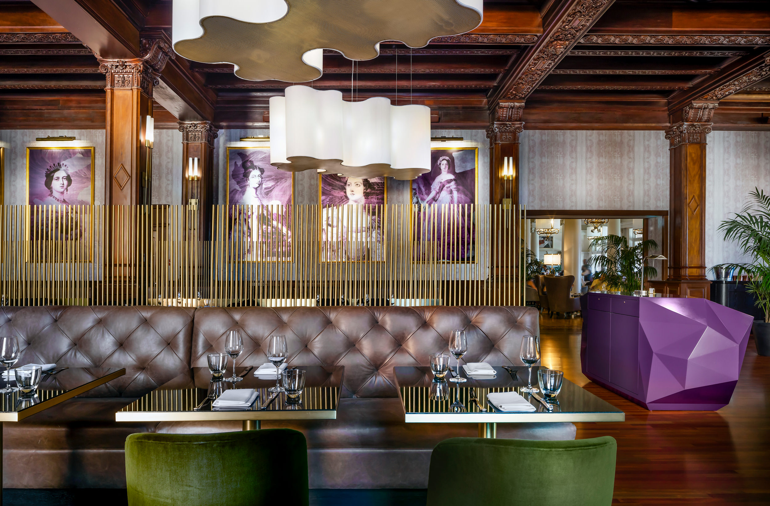 leather bench seating with purple portraits of Queen Victoria in the background