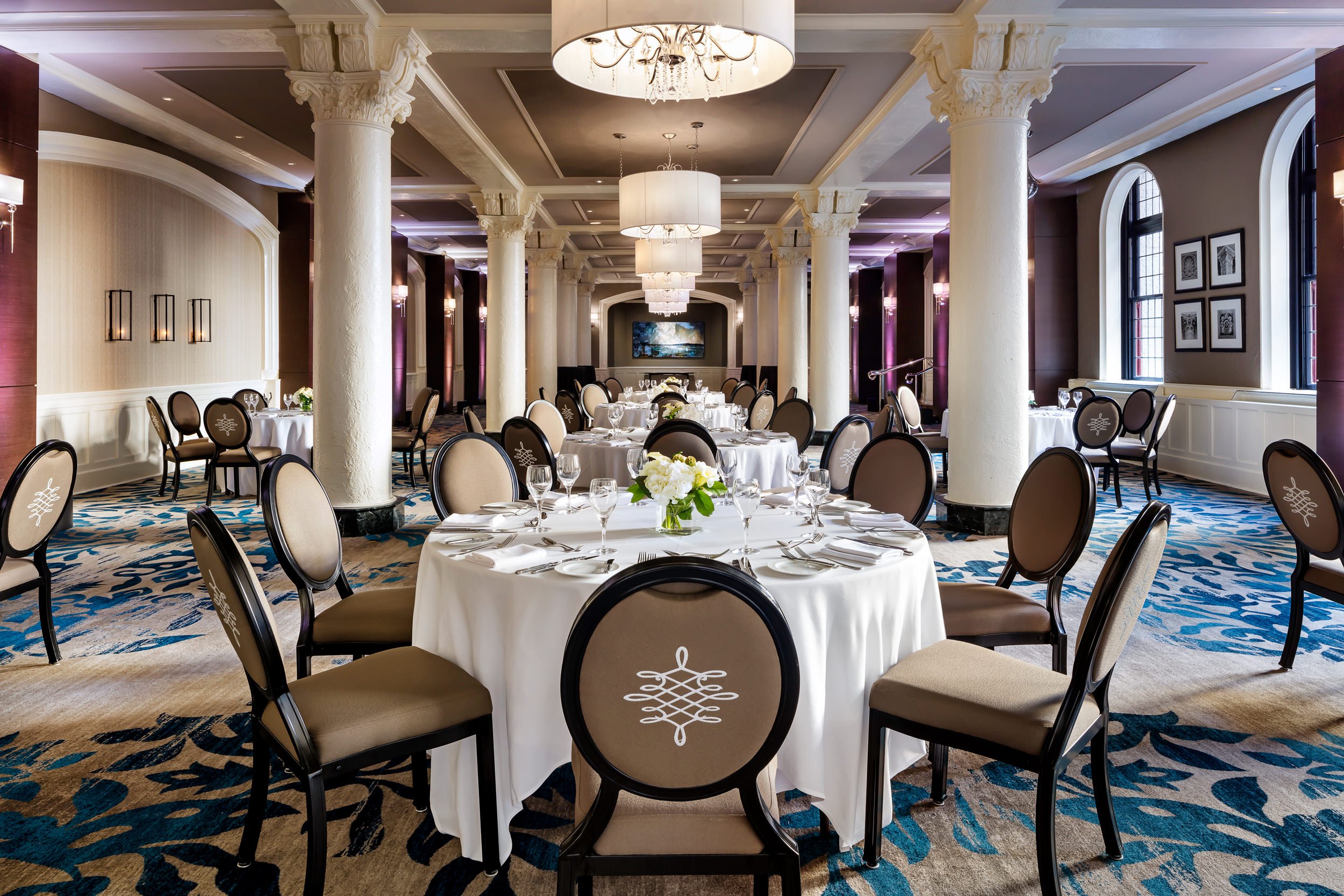 large room with dining tables set up for a wedding
