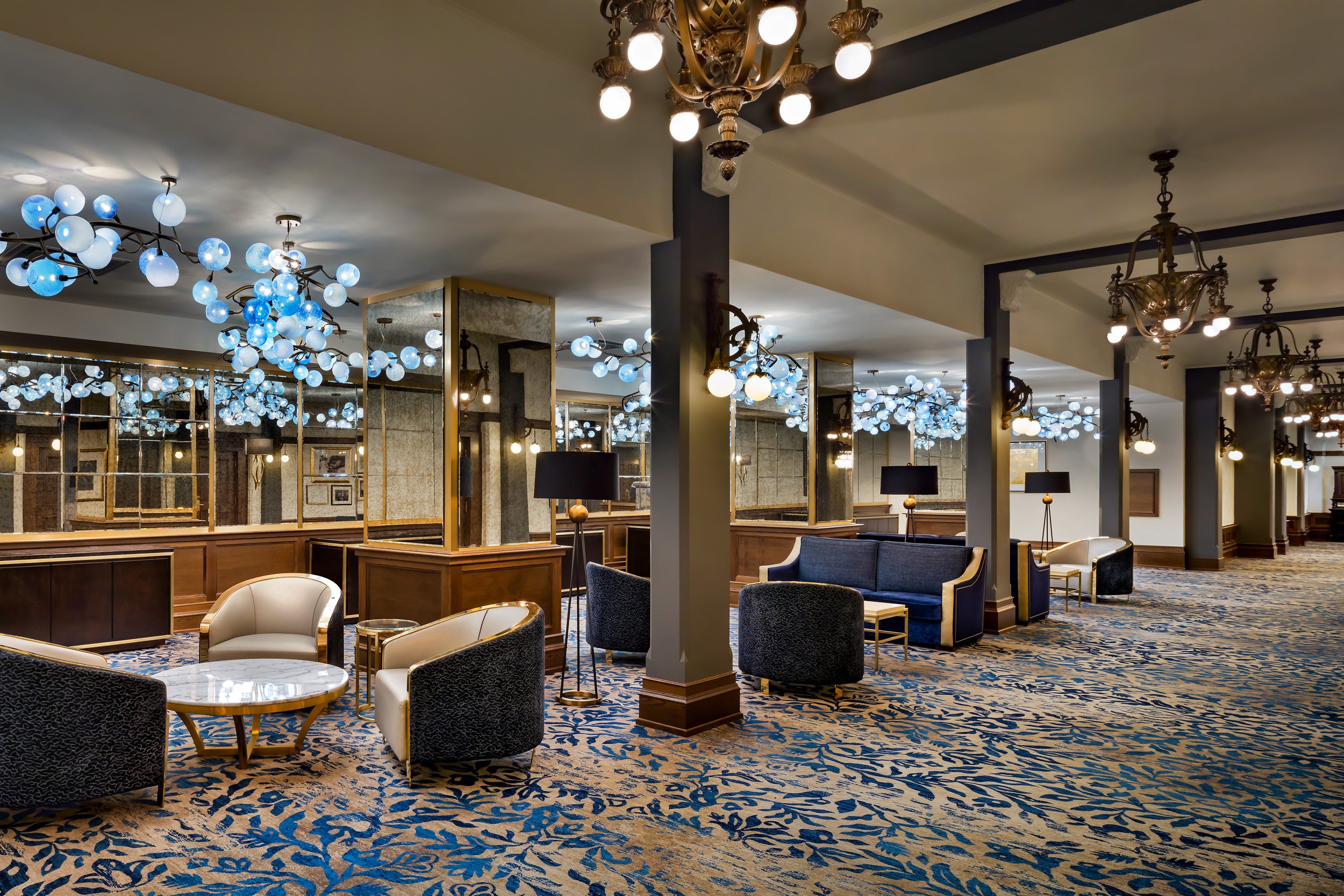 a large carpeted foyer with several lounge chairs
