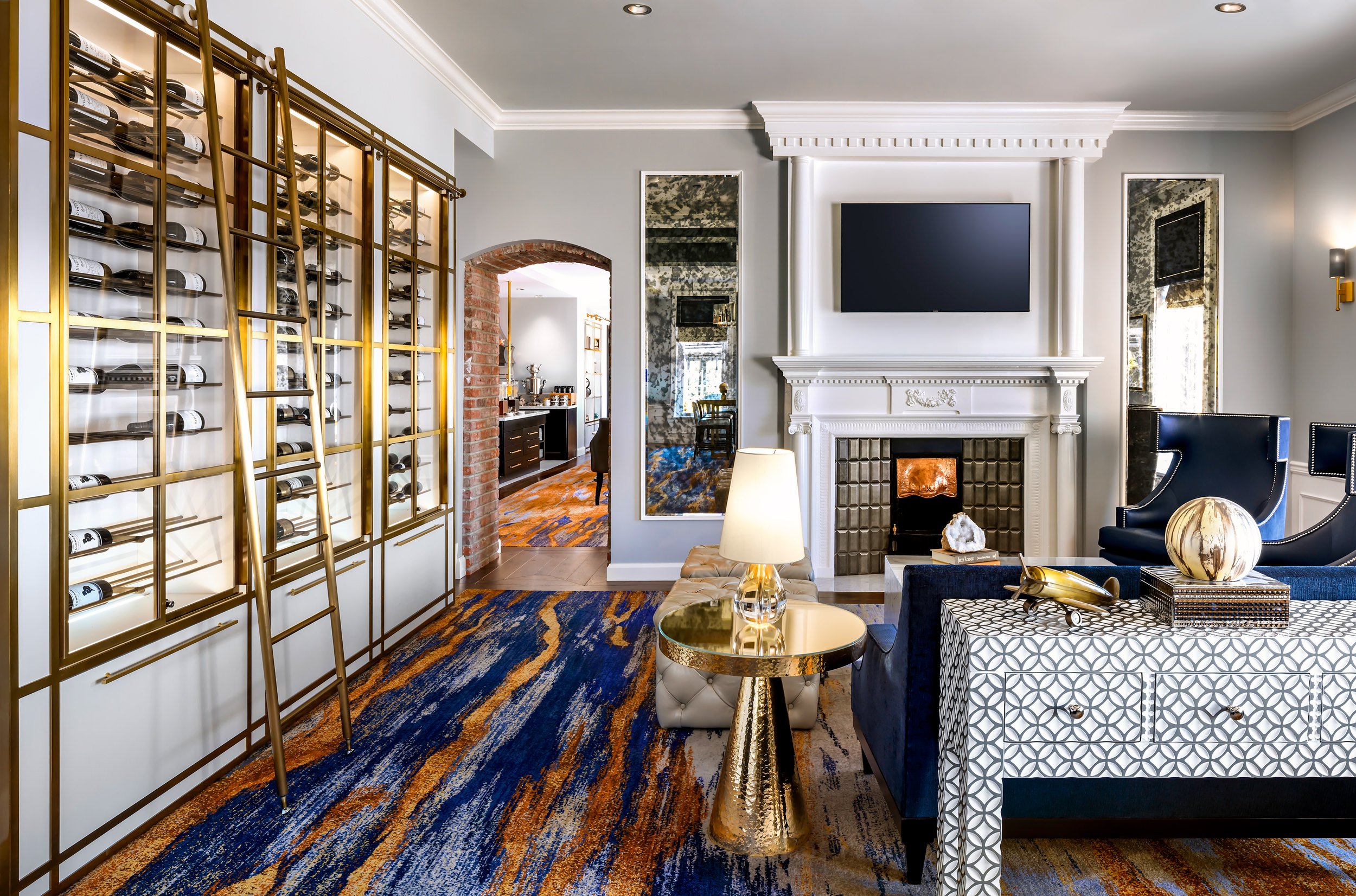 white room with blue lounge chairs in front of a fireplace and view of dining area