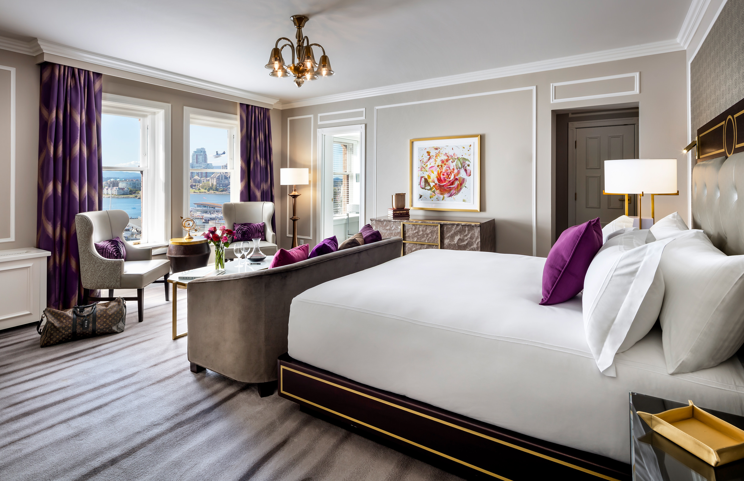 bedroom with sitting area and view of a harbour