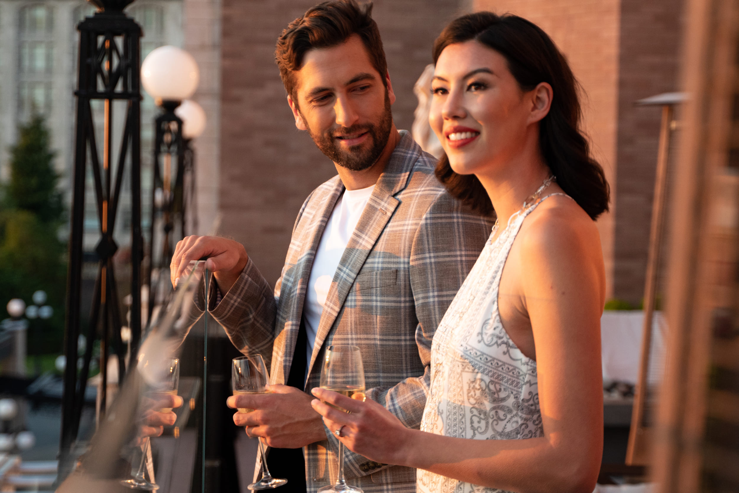 couple dressed up and watching the sunset on the balcony