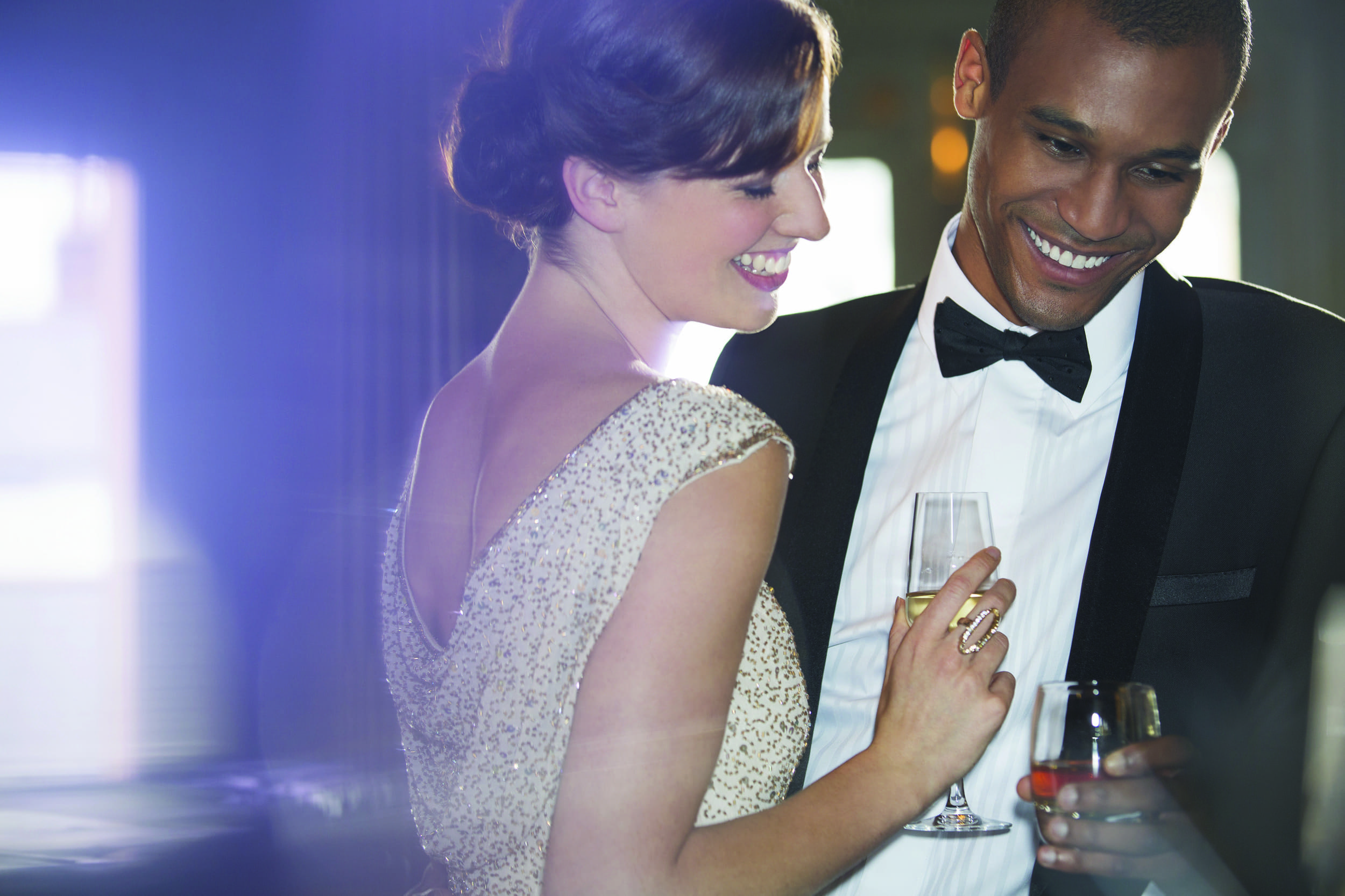 man and woman dressed nicely attending a party